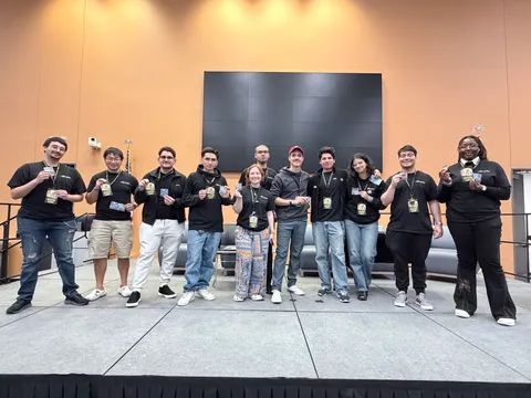 CSA officers and judges on stage at HackHCC, holding event badges